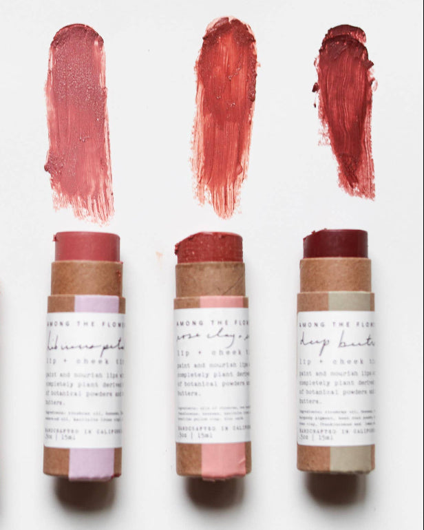 Set of six lip balm sticks with visible color swatches on a white background