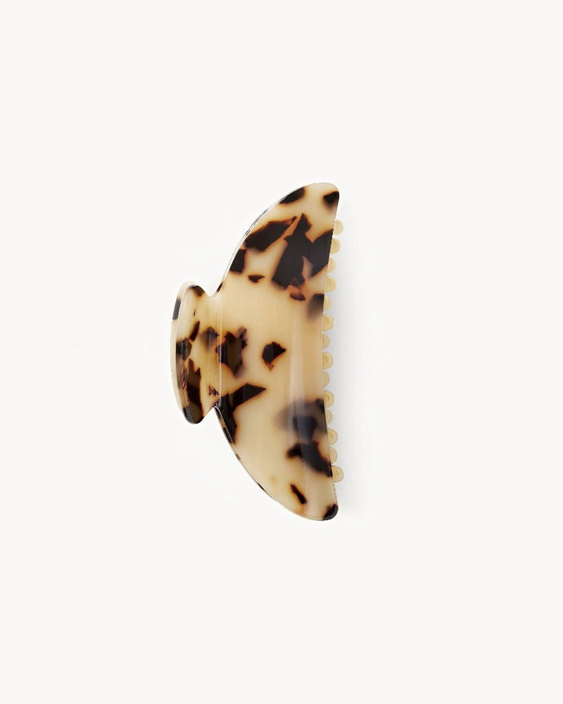 A double-walled, blonde tortoise patterned hair claw.