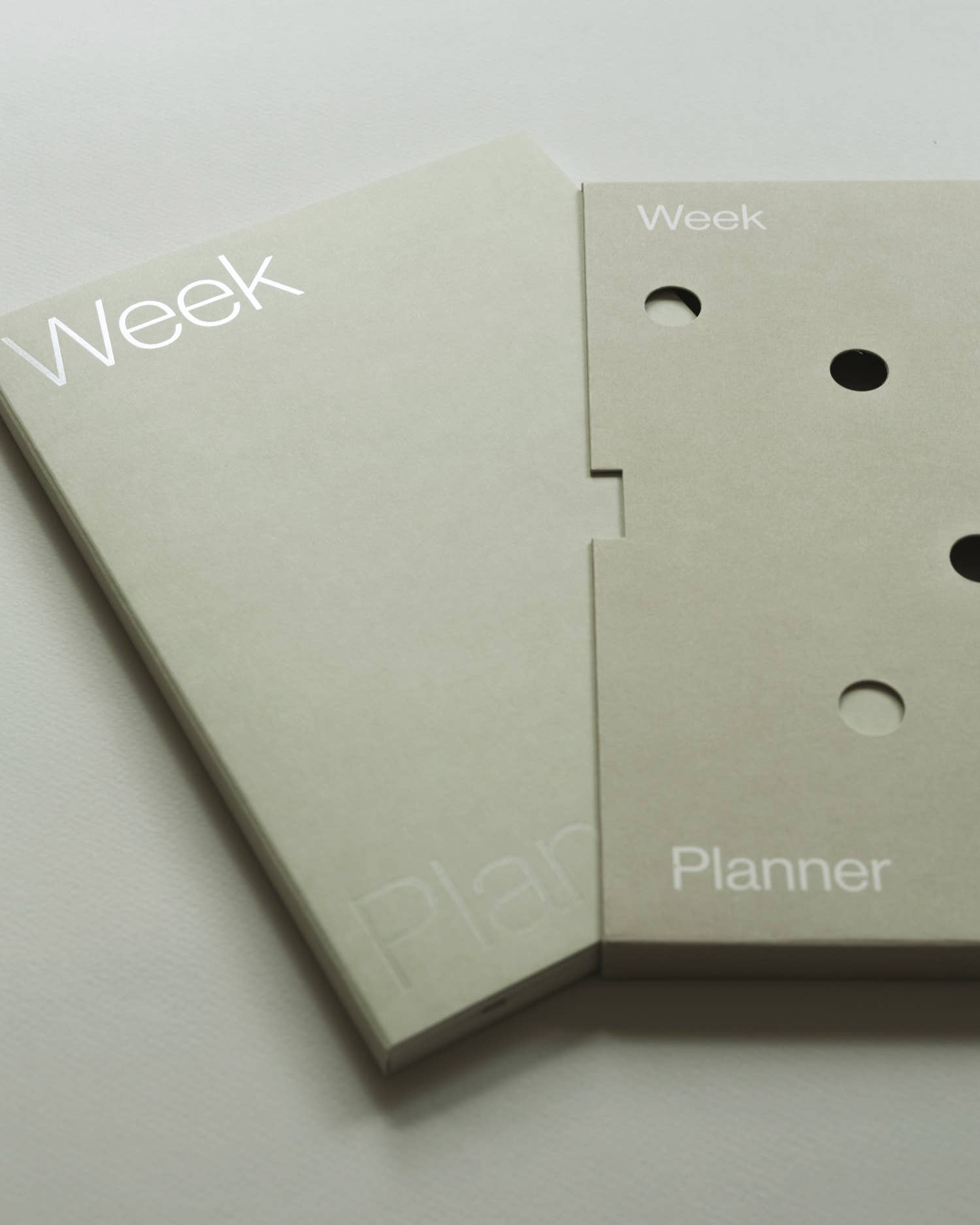 Two beige planner pages with 'Week' and 'Planner' text on a light gray background