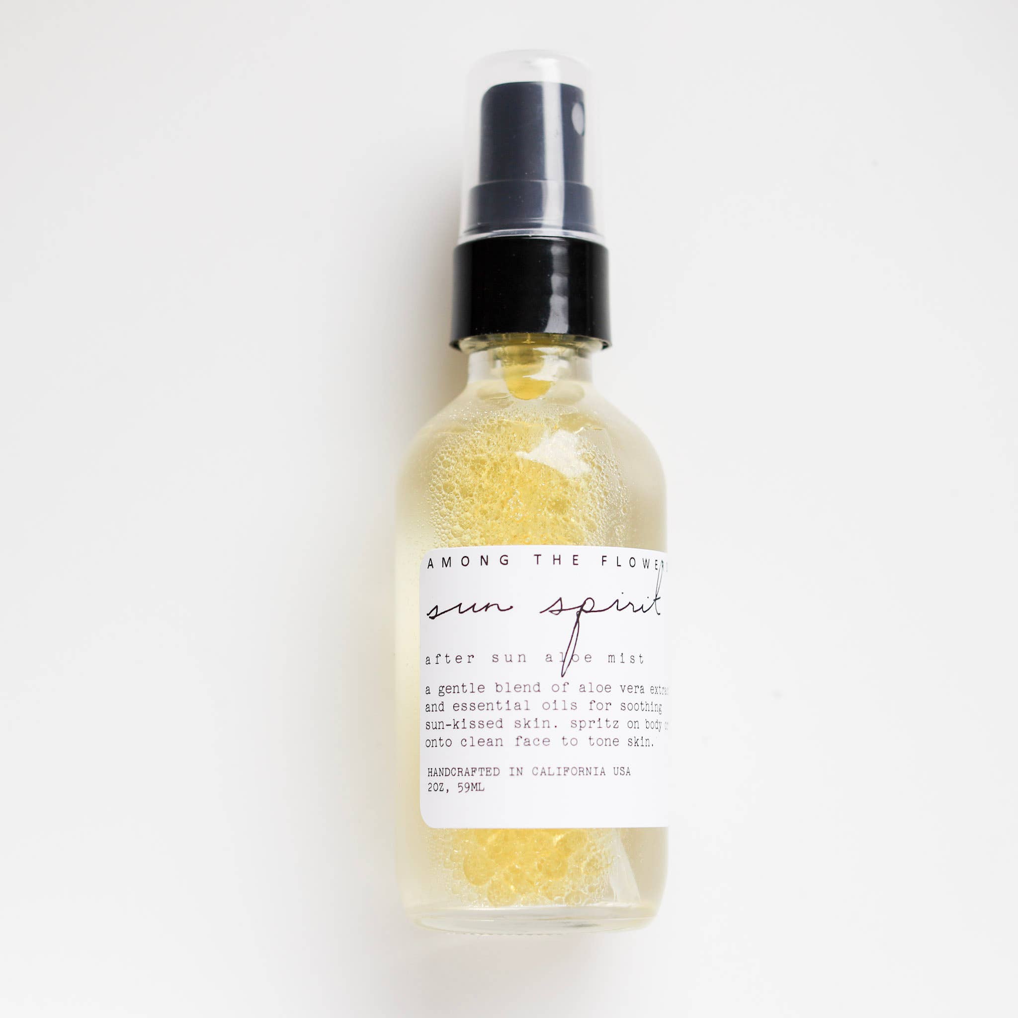 Bottle of 'Sun Spirit' after sun body mist with a white label on a light gray background