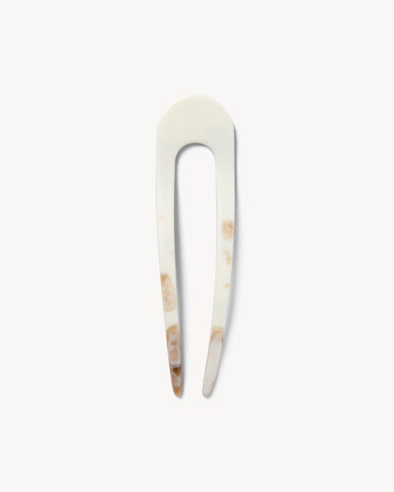 White and brown marbled hair pin with natural pattern on a white background