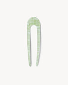 Green checkered hair pin on a white background