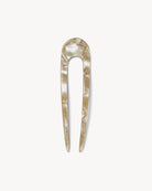 A beige French hair pin made of acetate, displayed against a white background.