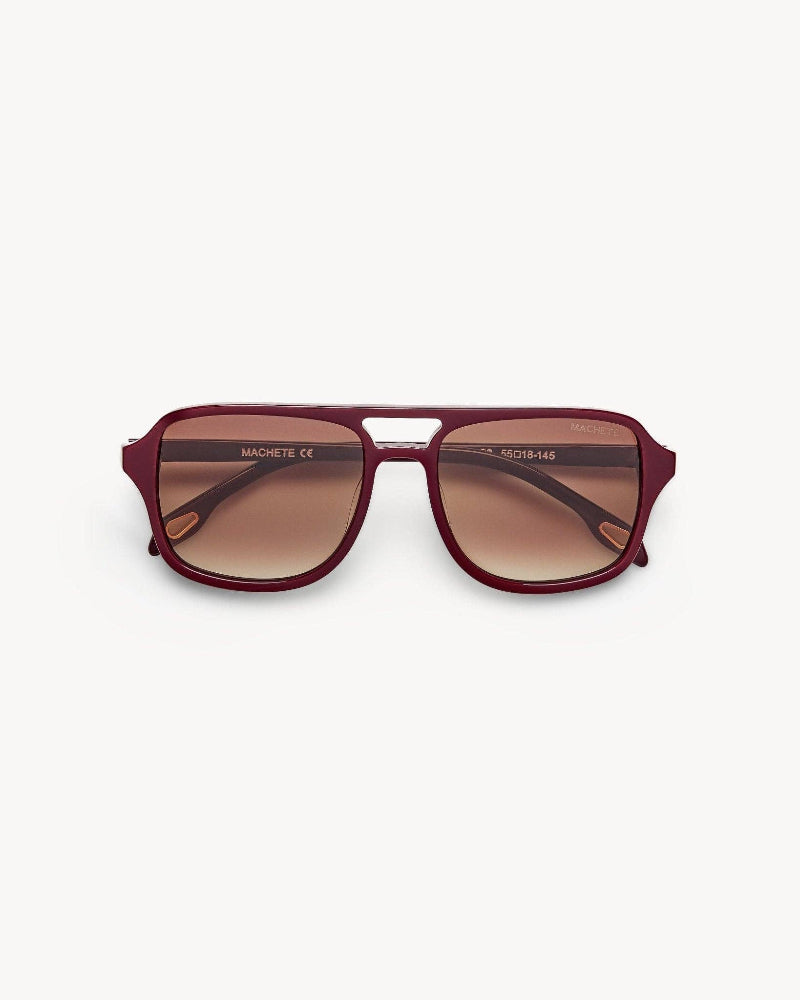 Maroon sunglasses with a brand logo on a white background