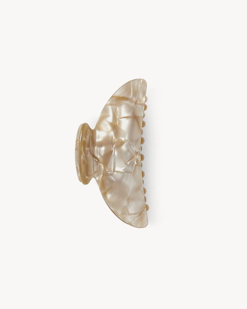 A double-walled, beige-colored hair claw made from Italian acetate, designed to hold medium volumes of hair.