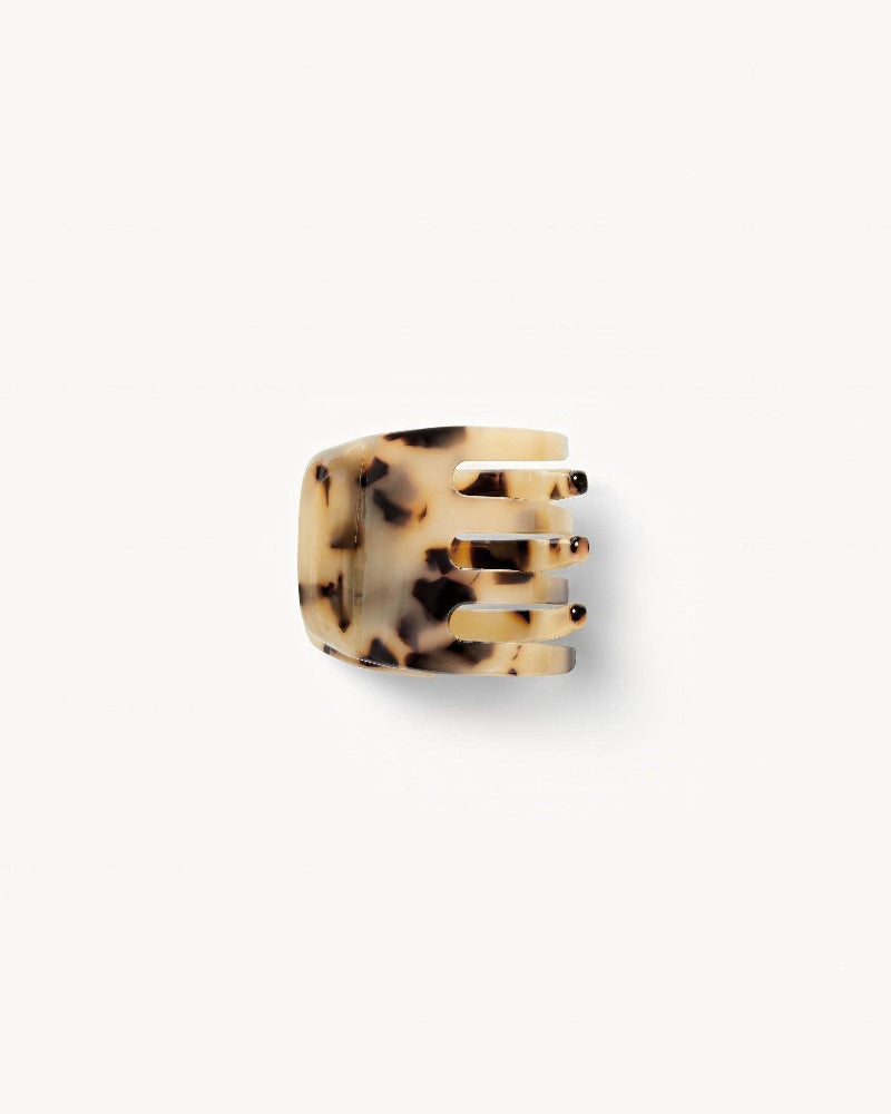 A handcrafted mini claw clip in a blonde tortoise color pattern.