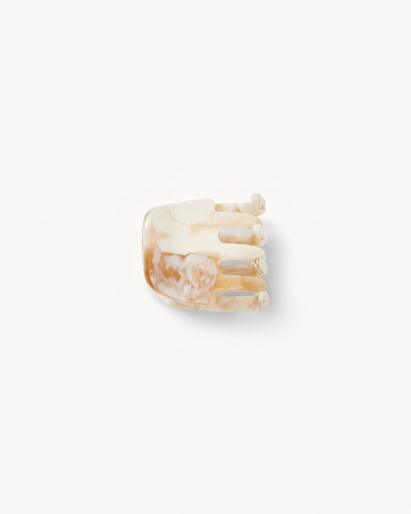 Beige hair clip on a white background