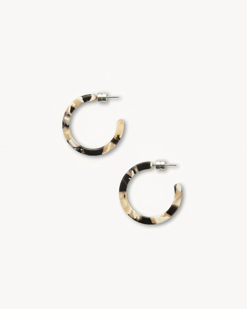 Pair of hoop earrings with black and beige pattern on a white background