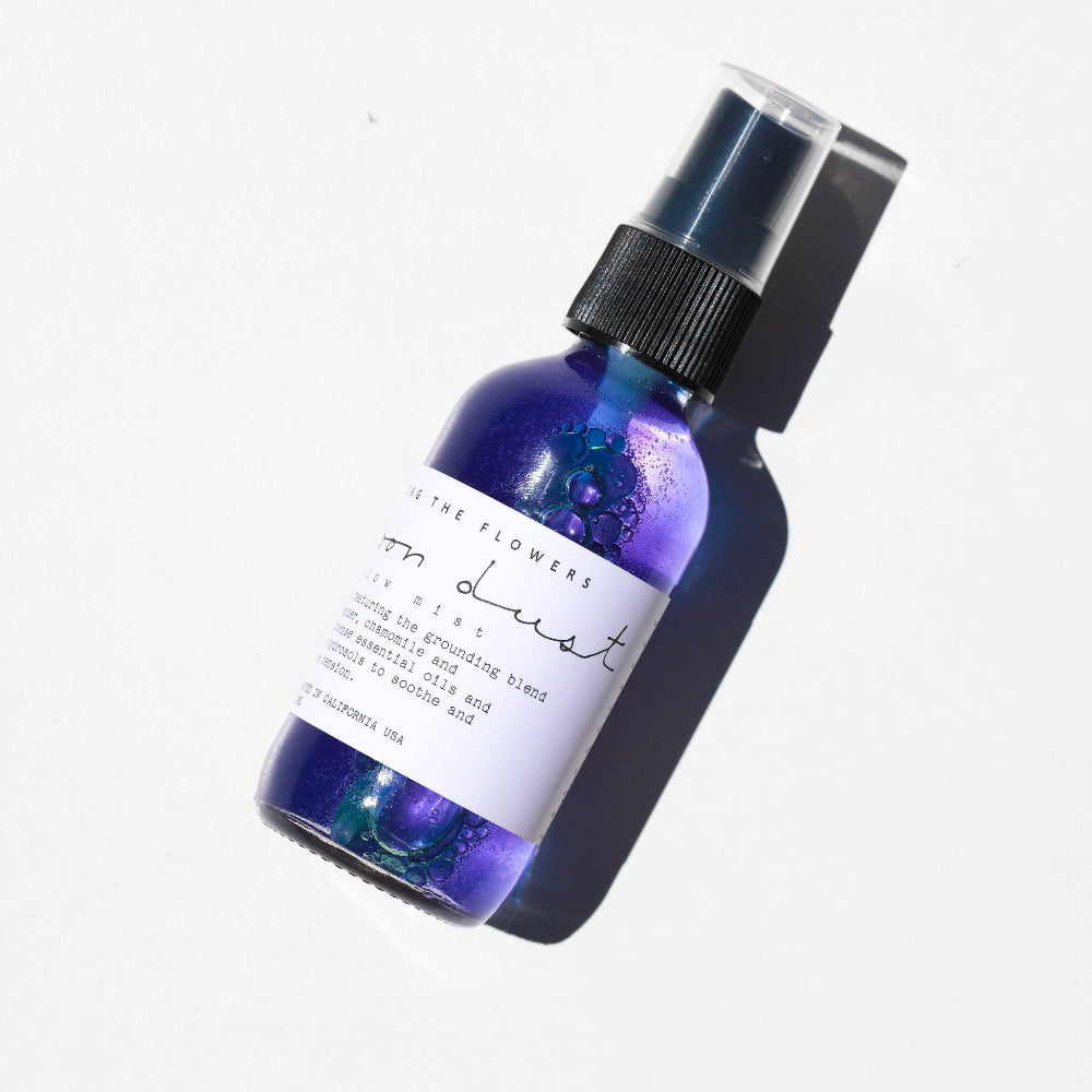 Purple bottle with a black spray nozzle on a white background
