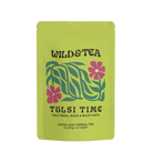 Green tea package with floral design and 'Wild & Tea' branding on a white background
