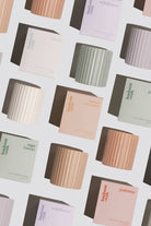 Pattern of Hudson Hawk candles and boxes on a light background
