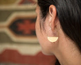 Model wearing half moon earrings by Material Wit.